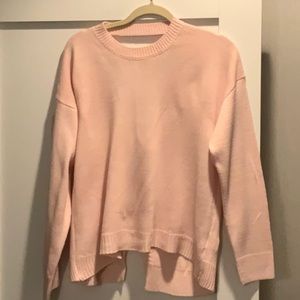 About Us pink sweater
